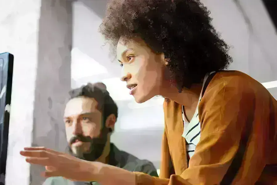 Lady and guy discussing over computer