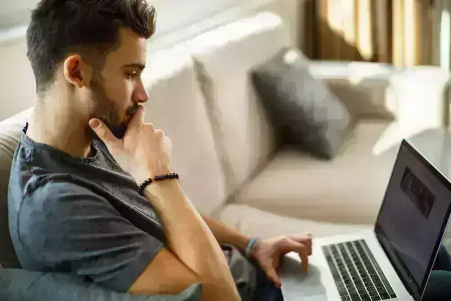 a student focused on his computer
