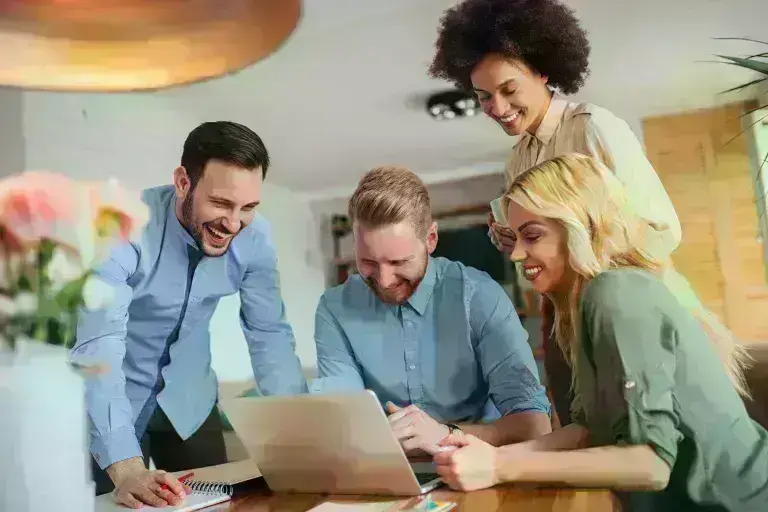 Professionals discussing in front of a laptop