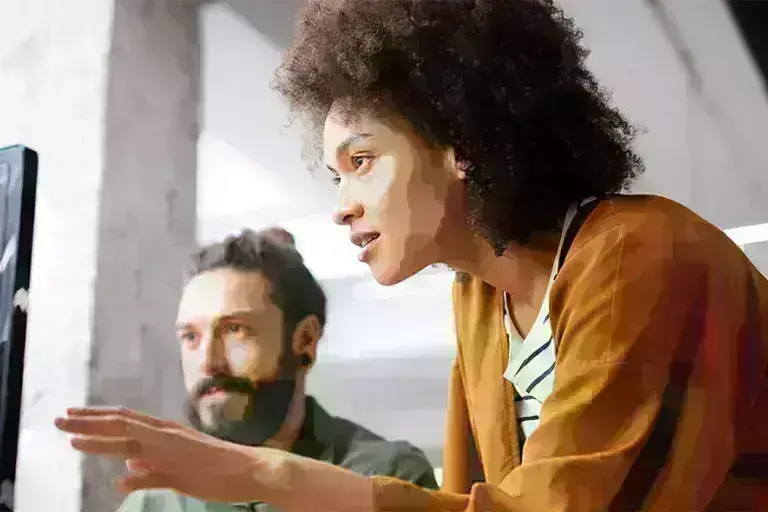 Lady and guy discussing over computer